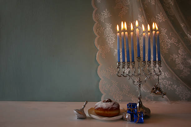 istock jewish holiday Hanukkah background with menorah 623345538