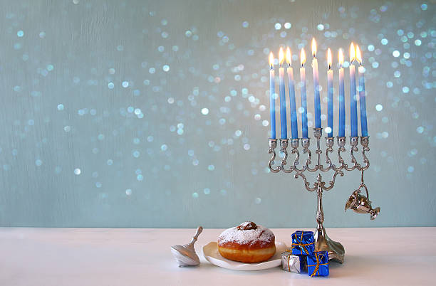 istock jewish holiday Hanukkah background with menorah 623345666