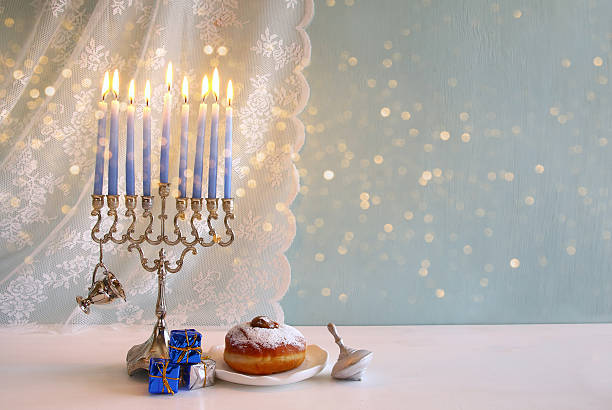 istock jewish holiday Hanukkah background with menorah 623345774