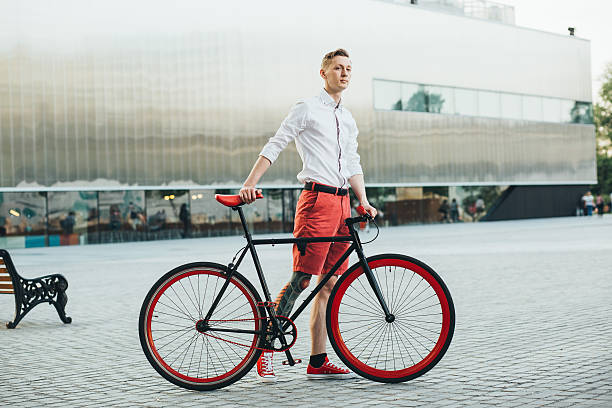 istock Hipster with red bycicle and tattoo on leg 623346476