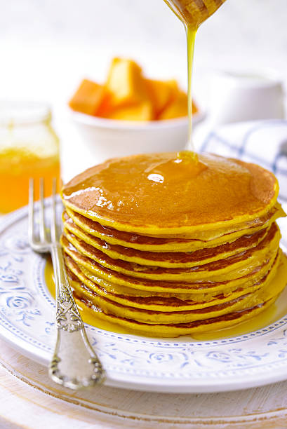 istock Pumpkin pancakes with honey for a breakfast. 623348524