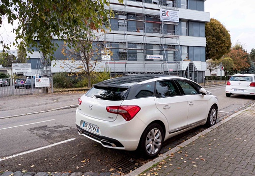 Strasbourg, France - November 6, 2016: Rear view of white Luxury DS 5 family van parked on French city street.The DS 5 is a upmarket large family car designed and developed by the French automaker Citroen that was launched for the European market in November 2011
