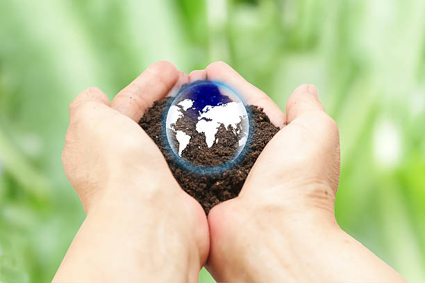 istock woman hands holding the earth on blurred green background 623352912