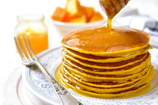istock Pumpkin pancakes with honey for a breakfast. 623353518