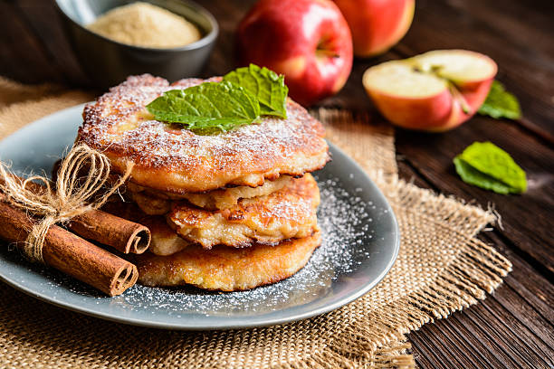 Sweet apple and curd pancakes Sweet pancakes made of apple, curd and cinnamon sprinkling powdered sugar stock pictures, royalty-free photos & images