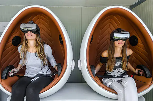 Happy family. Mother and her daughter using virtual reality glasses.
