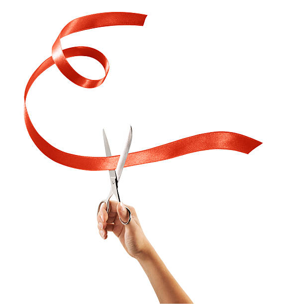 istock Scissors cutting through red ribbon or tape 623357982