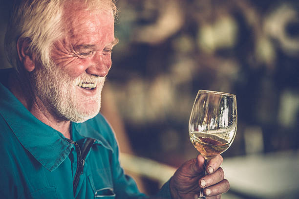 istock Senior Man with Beard Drinking Glass of White Wine 623359138