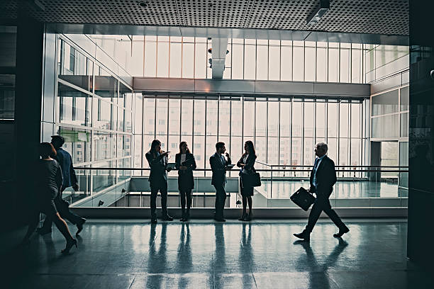 istock business people walking in office lobby 623361782