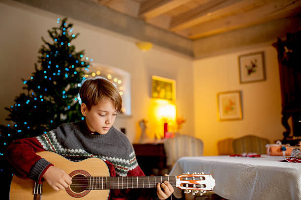 istock Little Boy Playing on Guitar on Christmas 623362704