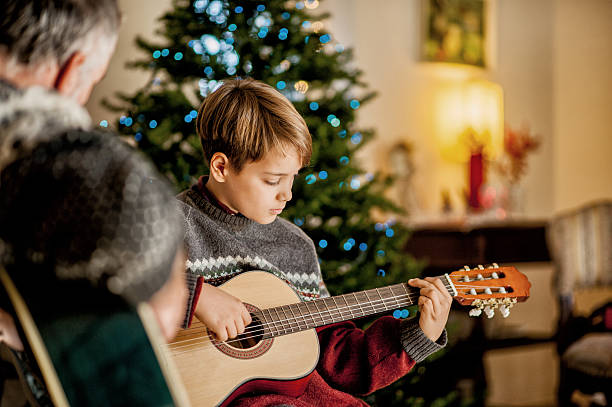 istock Father and Son playing on Guitar on Christmas 623362798