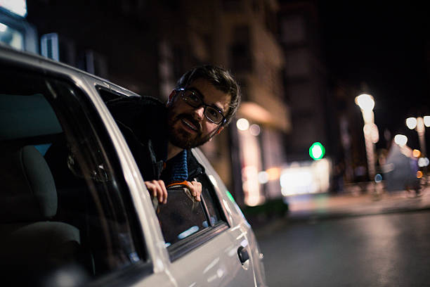 istock Bearded man enjoying in car in urban scene 623364206