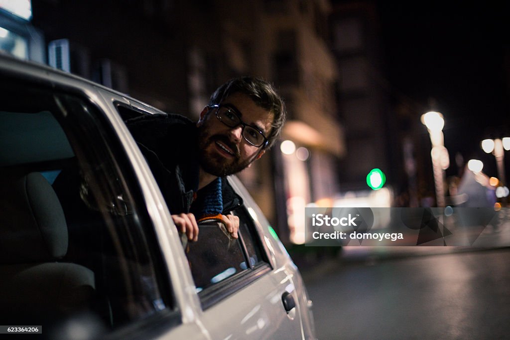 Bearded man enjoying in car in urban scene Car Stock Photo