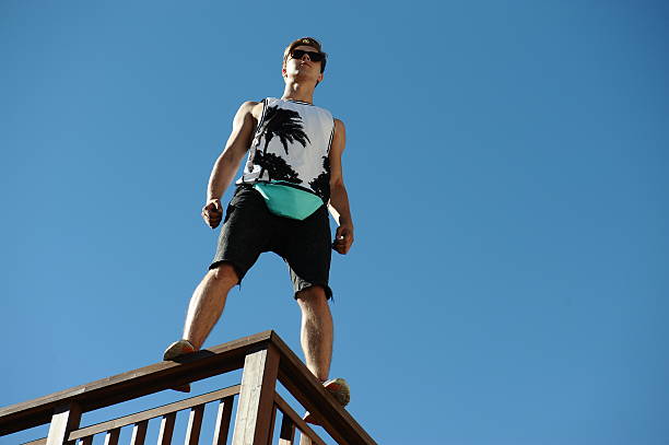 istock young man stands against a blue sky, 623364802