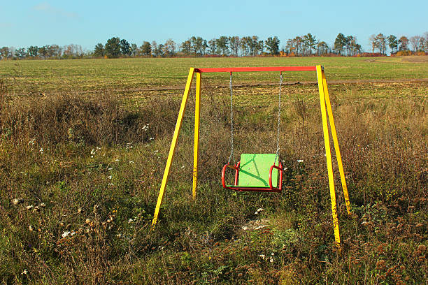 istock Empty swinging see saw in abandoned playground 623365532