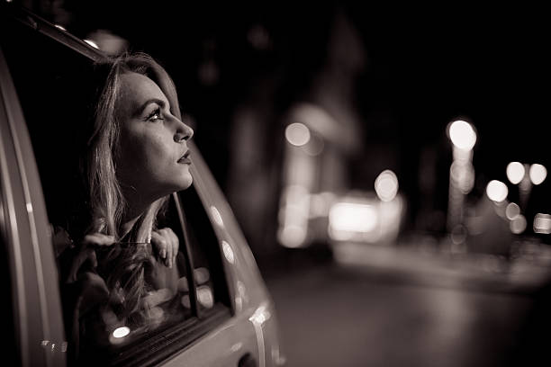 Beautiful woman peaking trough car windows