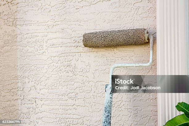 Paint Roller Attached To Pole On Outside Wall Of House Stock Photo - Download Image Now