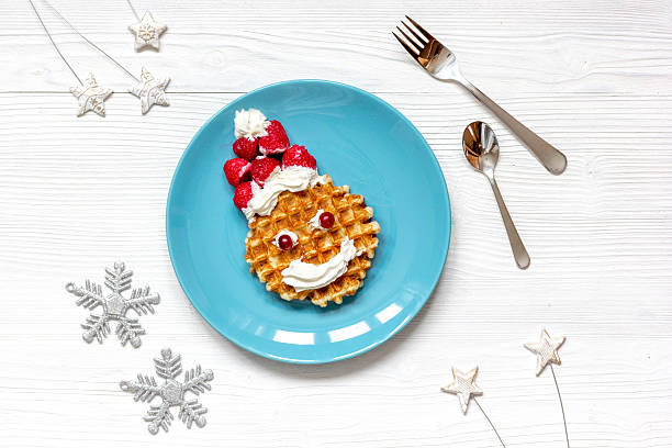 istock breakfast for child on Christmas with waffle top view 623367378