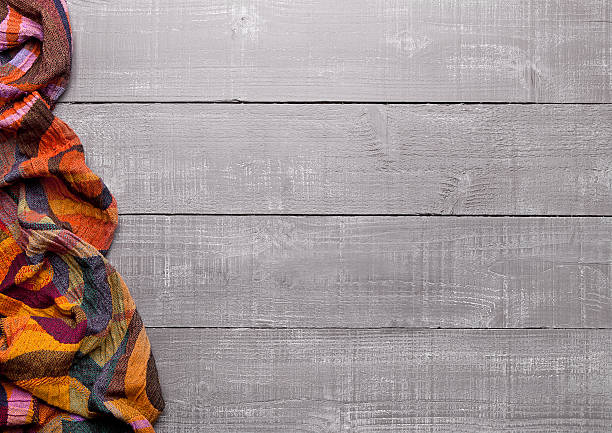 istock Warm soft wool scarf on wooden background texture 623368050