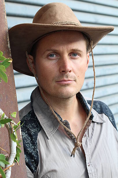 istock Young handsome man wearing cowboy hat 623368214