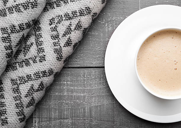 istock Cup of cappuccino with grey wool scarf on wood 623368468