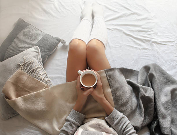 istock girl holding a cup of hot coffee 623368544