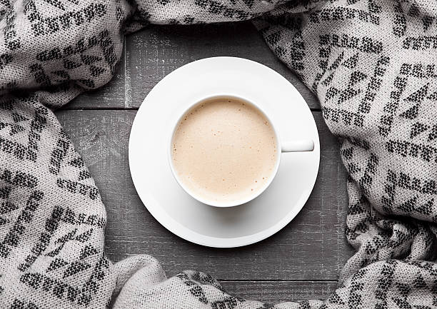 istock Cup of cappuccino with grey wool scarf on wood 623368608
