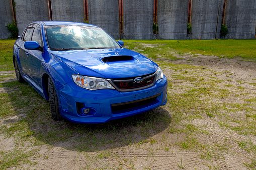 Tampa, FL, USA - June 25, 2016 - Subaru Impreza WRX front and left side view, parked and photographed in an industrial setting near the Port of Tampa in the city of Tampa, FL.
