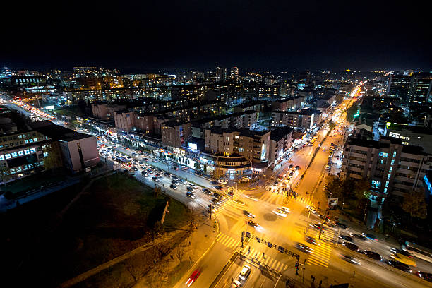 Night view of a crossroad in Pristina, Kosovo capital city Night view of the crossroad between Bill Clinton Boulevard and George W Bush Boulevard seen from the Mother Tereza Cathedral in Pristina, capital city of Kosovo. pristina stock pictures, royalty-free photos & images