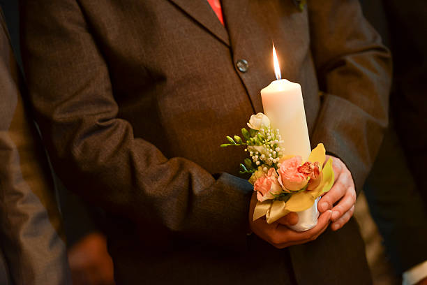 istock Groom holding a lighted candle in church 623370902