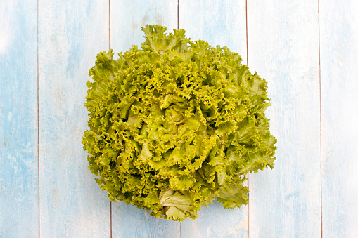 Lettuce on a blue wooden board, top view