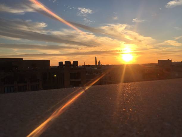 istock sun setting over the United States Capitol on a clear 623372862