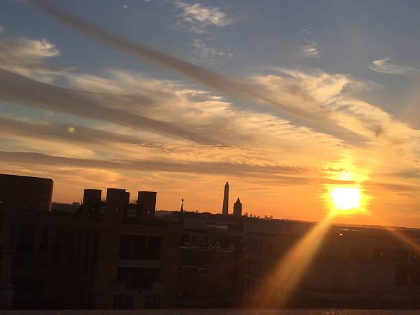 istock sun setting over the United States Capitol on a clear 623373070