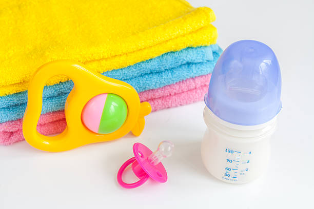 istock baby bottle with milk and towel on white background 623373554