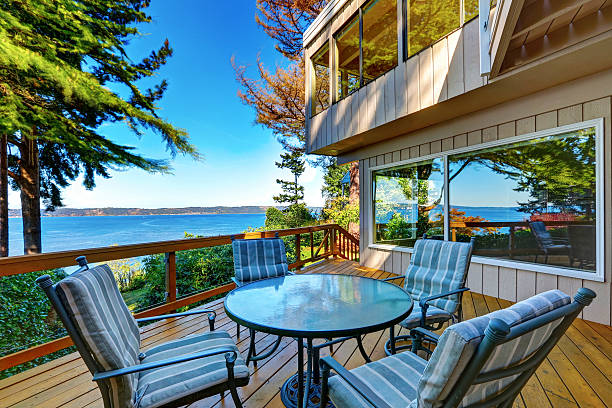 istock Glass top table with chairs on a wooden walkout deck. 623373780