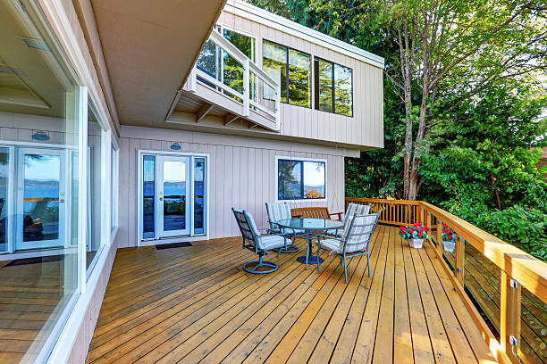 istock Wooden walkout deck with outdoor table set and swinging bench 623373914