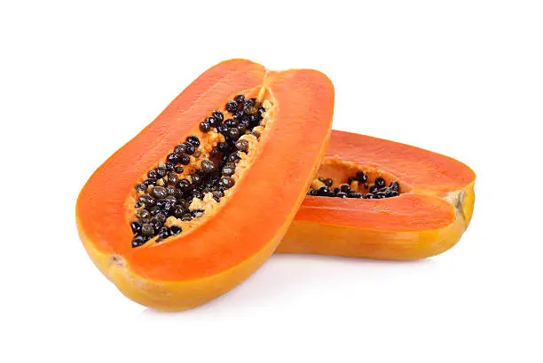 half cut ripe papaya with seed on white background