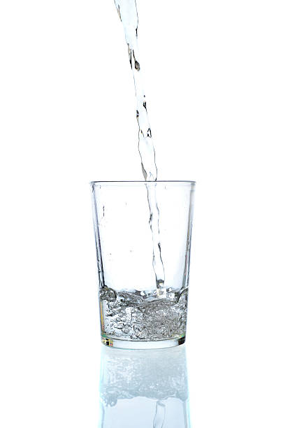 istock Fresh water pouring in a glass on white background 623374116