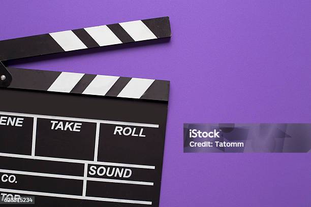 Movie Clapper On Violet Background Stock Photo - Download Image Now - Movie, Backgrounds, Film Reel
