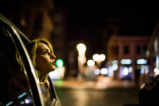 istock Beautiful woman peaking trough car windows 623375476