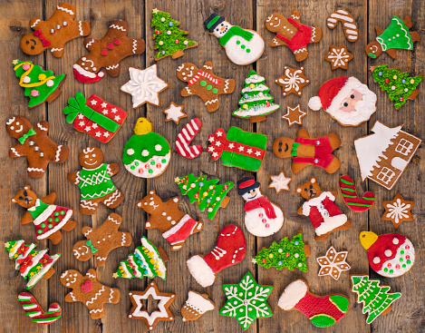 Delicious beautiful Christmas gingerbread cookies on wooden rustic table. Used gingerbread cookies home-handedly made it from me. They are unique pieces and can not be found anywhere.