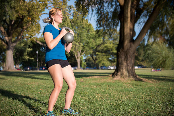 istock Young fit woman doing squats with heavy kettlebell 623376440