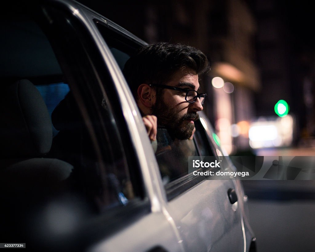 Bearded man enjoying in car in urban scene Addiction Stock Photo