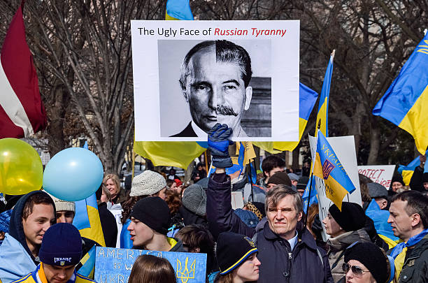 Ukrainian protest by White House with Stalin and Putin sign Washington DC, USA - March 6, 2014: Crowd of people at Ukrainian protest by White House with Stalin and Putin sign golden ring of russia photos stock pictures, royalty-free photos & images
