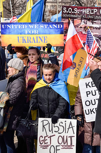 Crowd of people at Ukrainian protest with flags Washington DC, USA - March 6, 2014: Crowd of people at Ukrainian protest with flags, signs and banners vladimir russia photos stock pictures, royalty-free photos & images