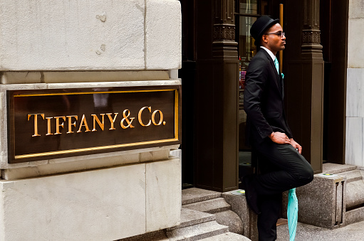 New York City, USA - May 11, 2015: Tiffany & Co. Building on Wall Street in the Financial District with doorman employee in color coordinated suit