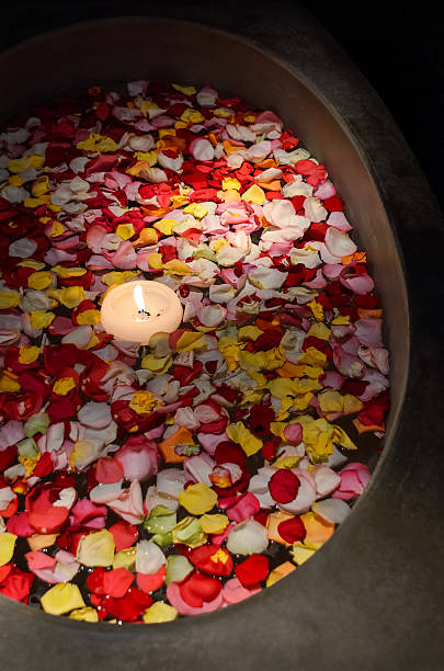 istock Bath with floating rose petals and candle 623377872