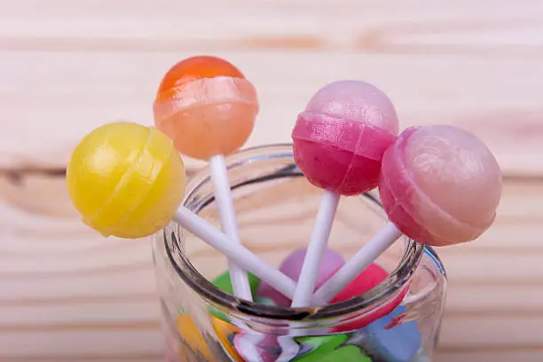 Photo of Lolopops in jar on wooden table