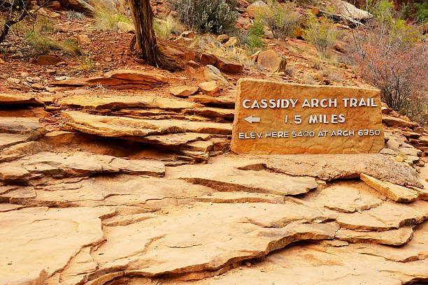 Cassidy Arch Trailhead Sign Stone trailhead sign at the start of the Cassidy Arch Trail at Capitol Reef National Park. garfield county montana stock pictures, royalty-free photos & images