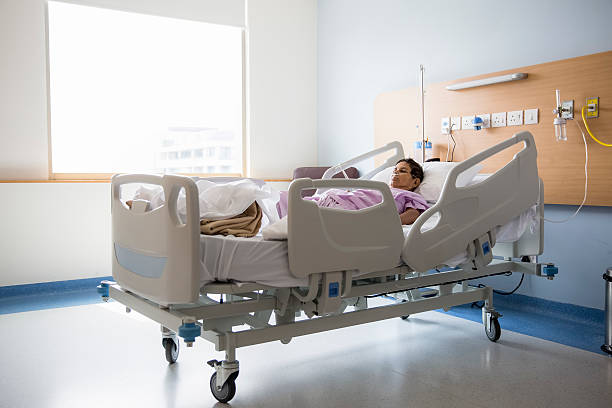 Old woman on Hospital bed, Oxygen tubes in her nose stock photo